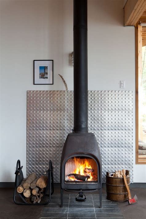 sheet metal wood stove surround|wall behind wood burning stove.